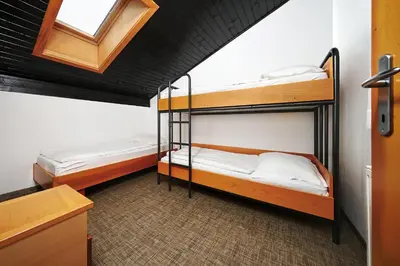 two bunk beds in a room with a window at Depandansa Brinje in Zreče