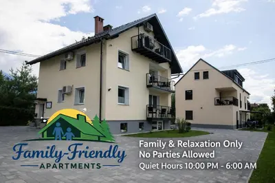 a house with a sign that says family friendly apartments at Apartments Razingar 9 in Bled