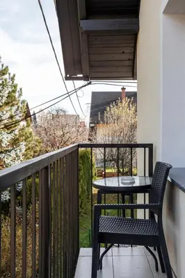a balcony with a table and chair on a balcony at Apartments Razingar 9 in Bled