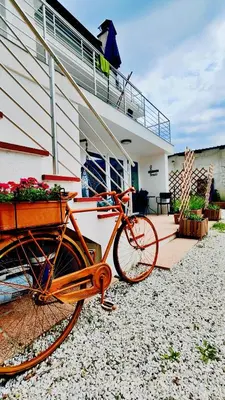 an orange bike parked in front of a house at Soča Home Bovec in Bovec