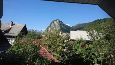 a view of a garden with mountains in the background at Apartmaji Marinka Hodnik in Bohinj