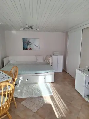 a bedroom with a bed and a table and chairs at Apartmaji Marinka Hodnik in Bohinj