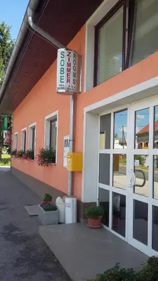 a building with a sign on the side of it at Bed and Breakfast Kreft in Ljutomer