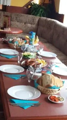 a table with plates of food and wine glasses at Bed and Breakfast Kreft in Ljutomer