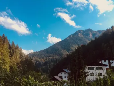 a view of a mountain with houses and trees at Apartment Tisa in Solčava