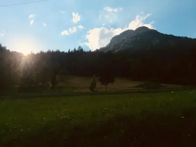 a field of grass with a mountain in the background at Apartment Tisa in Solčava