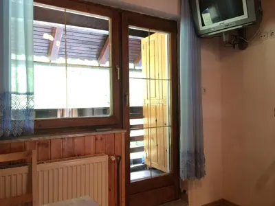 a window in a room with a tv and a window at Apartment Tisa in Solčava