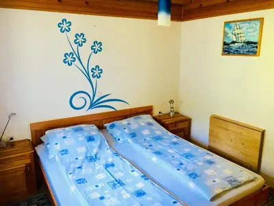 a bedroom with a bed with water bottles on the wall at Apartment Tisa in Solčava