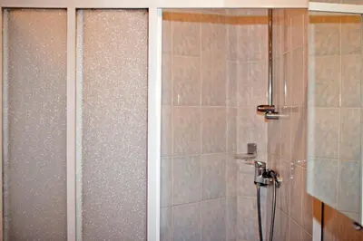 a bathroom with a shower and a toilet in it at Tourist farm Mraz in Podčetrtek