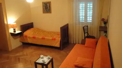 a small bedroom with a bed and a couch at Authentic traditional Soca Valley home in Kanal