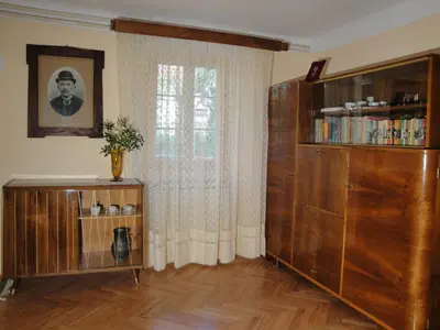 a living room with a large wooden cabinet and a window at Authentic traditional Soca Valley home in Kanal