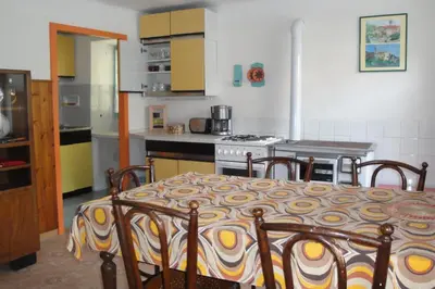 a kitchen with a table and a stove in it at Authentic traditional Soca Valley home in Kanal