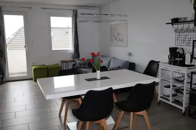 a dining room with a white table and chairs at Apartma Javoršček in Bovec