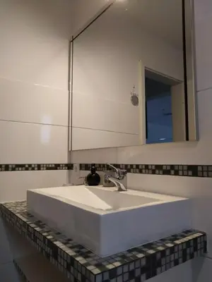 a bathroom with a white sink and a mirror at Apartma Javoršček in Bovec