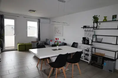 a living room with a white table and chairs at Apartma Javoršček in Bovec