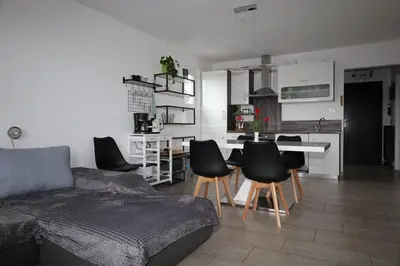 a living room with a couch and a table and chairs at Apartma Javoršček in Bovec