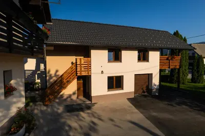 a white house with a brown roof at Apartment Ajda Bled in Bled