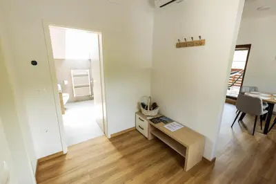a living room with a table and a mirror at Apartment Ajda Bled in Bled