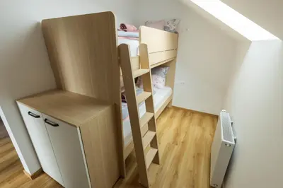 a small room with a bunk bed and a small desk at Apartment Ajda Bled in Bled