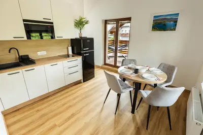 a kitchen and dining room with a table and chairs at Apartment Ajda Bled in Bled