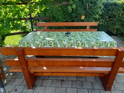 a wooden bench with a table on a patio at Apartment Ajda Bled in Bled