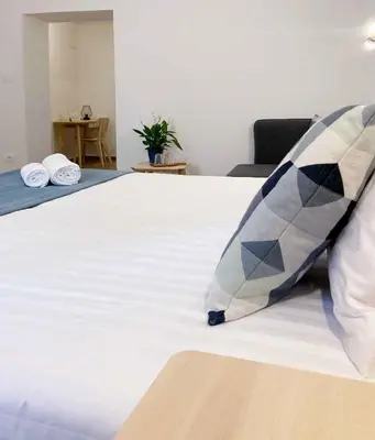 a bed with two pillows sitting on top of it at Soca Guesthouse in Kanal