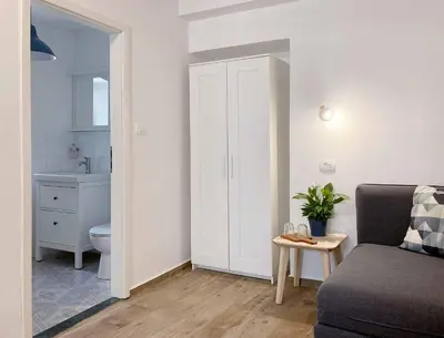 a living room with a couch and a bathroom at Soca Guesthouse in Kanal
