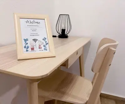 a wooden table with a sign on top of it at Soca Guesthouse in Kanal