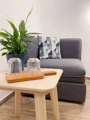 a coffee table with two glasses and a couch at Soca Guesthouse in Kanal