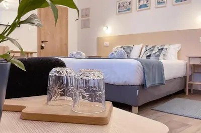 a bedroom with a bed and two glasses on a table at Soca Guesthouse in Kanal