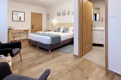 a bedroom with a bed and a living room at Soca Guesthouse in Kanal