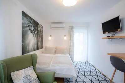 a small room with a bed and a chair at House 24 Bled in Bled