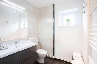 a bathroom with a toilet and a sink and a shower at House 24 Bled in Bled