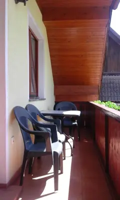 a row of chairs and tables on a porch at Apartment Korošec Matej in Bohinj