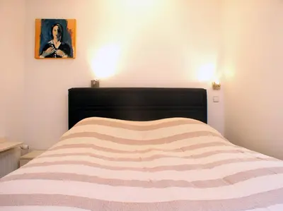 a bed with a black headboard in a bedroom at Charming Terrace Apartments Ana and Maria Tour As Ljubljana in Ljubljana