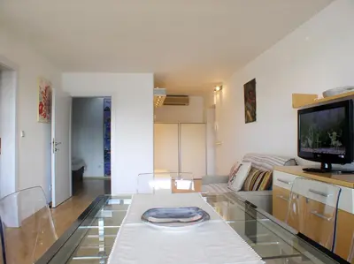 a living room with a glass table and a tv at Charming Terrace Apartments Ana and Maria Tour As Ljubljana in Ljubljana