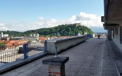 a balcony of a building with a view of a city at Charming Terrace Apartments Ana and Maria Tour As Ljubljana in Ljubljana