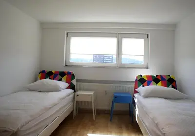 two beds in a small room with a window at Charming Terrace Apartments Ana and Maria Tour As Ljubljana in Ljubljana