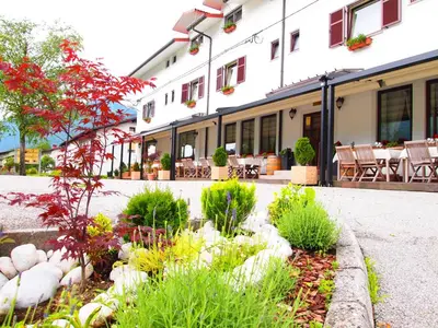 a garden in front of a building at Gostišče Jazbec - Idrsko - Kobarid in Kobarid