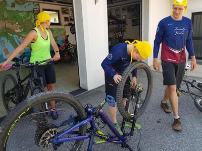 a group of people in hats looking at a bike at Gostišče Jazbec - Idrsko - Kobarid in Kobarid