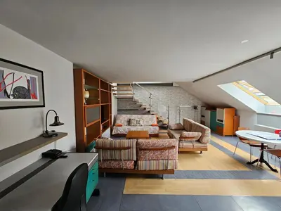 a living room with a couch and a table at Jazz Apartment Tour As Ljubljana in Ljubljana