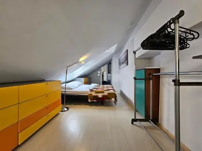 a bedroom with a bed and a dresser in a room at Jazz Apartment Tour As Ljubljana in Ljubljana