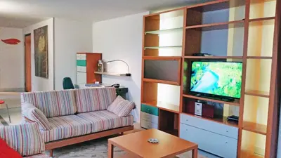a living room with a couch and a tv at Jazz Apartment Tour As Ljubljana in Ljubljana