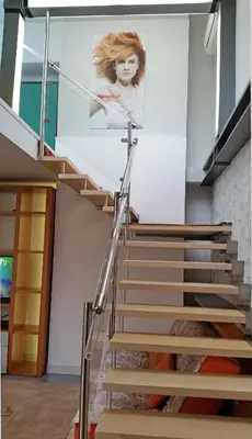 a staircase in a house with a poster on the wall at Jazz Apartment Tour As Ljubljana in Ljubljana