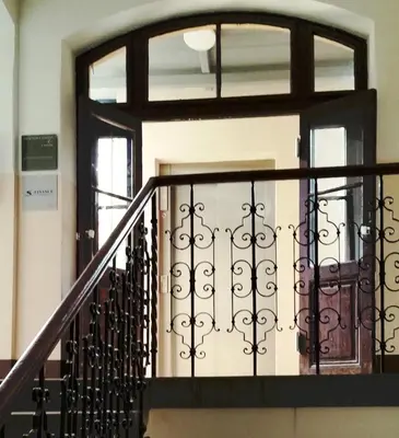 a staircase with a wrought iron railing and a window at Jazz Apartment Tour As Ljubljana in Ljubljana