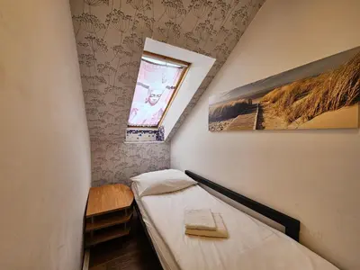 a small room with two beds and a window at Jazz Apartment Tour As Ljubljana in Ljubljana