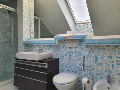 a bathroom with a toilet and a sink and a mirror at Jazz Apartment Tour As Ljubljana in Ljubljana