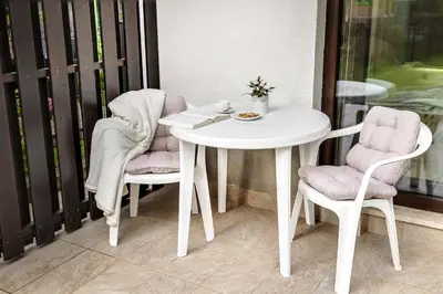 a white table and two chairs on a balcony at Apartments Svetina in Bled