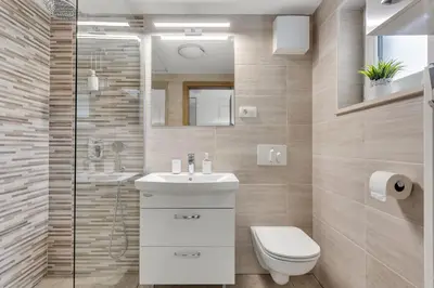a bathroom with a toilet and a sink and a shower at Apartments Svetina in Bled