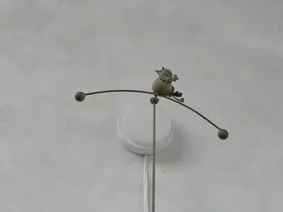 a small bird sitting on top of a pole at Apartmaji Hedera in Komen